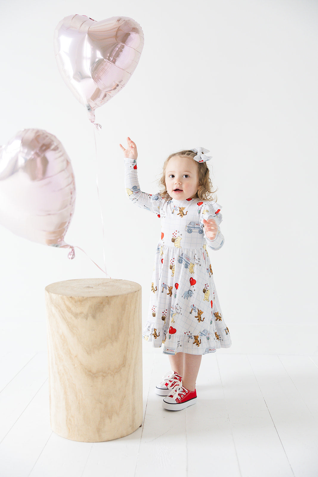 Vintage Winnie the Pooh bamboo twirl dress with Tigger, Eeyore and Piglet in a Valentine's Day print for baby and toddler boys and girls.