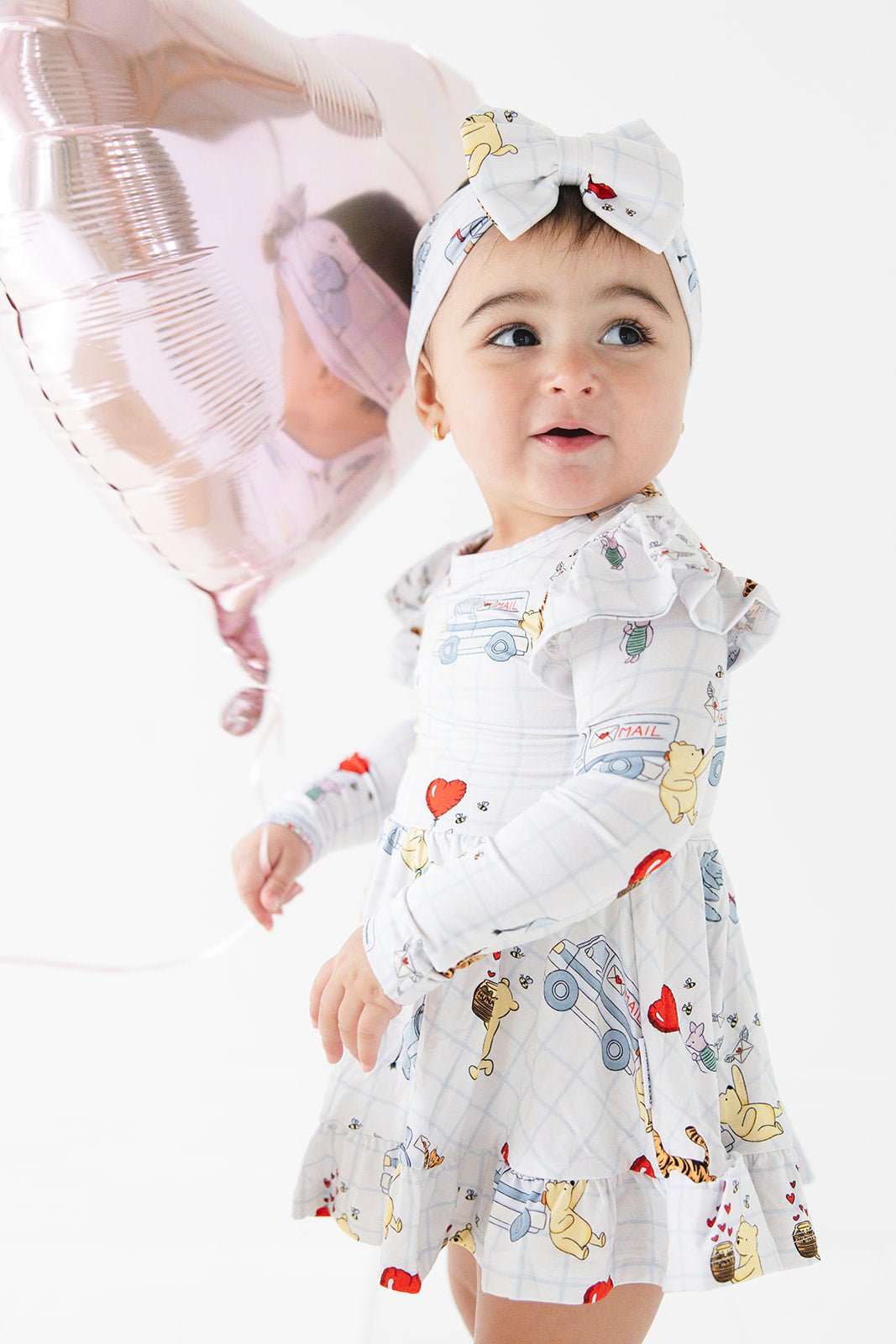 Vintage Winnie the Pooh bamboo twirl dress with Tigger, Eeyore and Piglet in a Valentine's Day print for baby and toddler boys and girls.