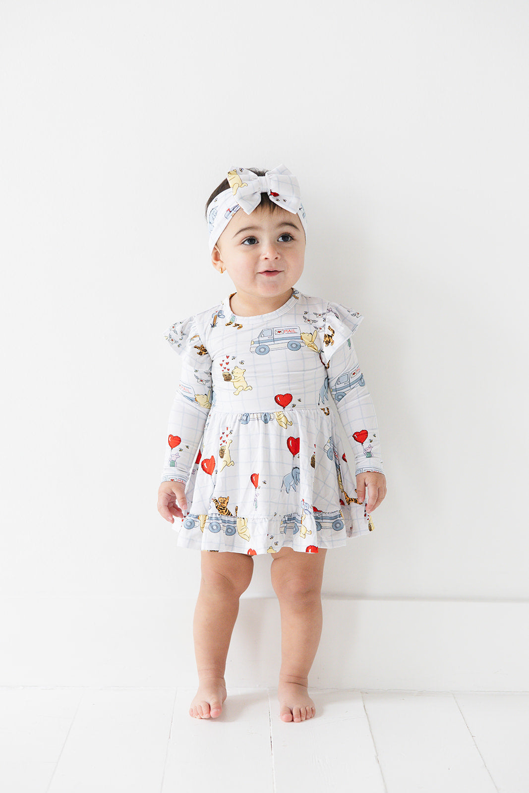 Vintage Winnie the Pooh bamboo twirl dress with Tigger, Eeyore and Piglet in a Valentine's Day print for baby and toddler boys and girls.