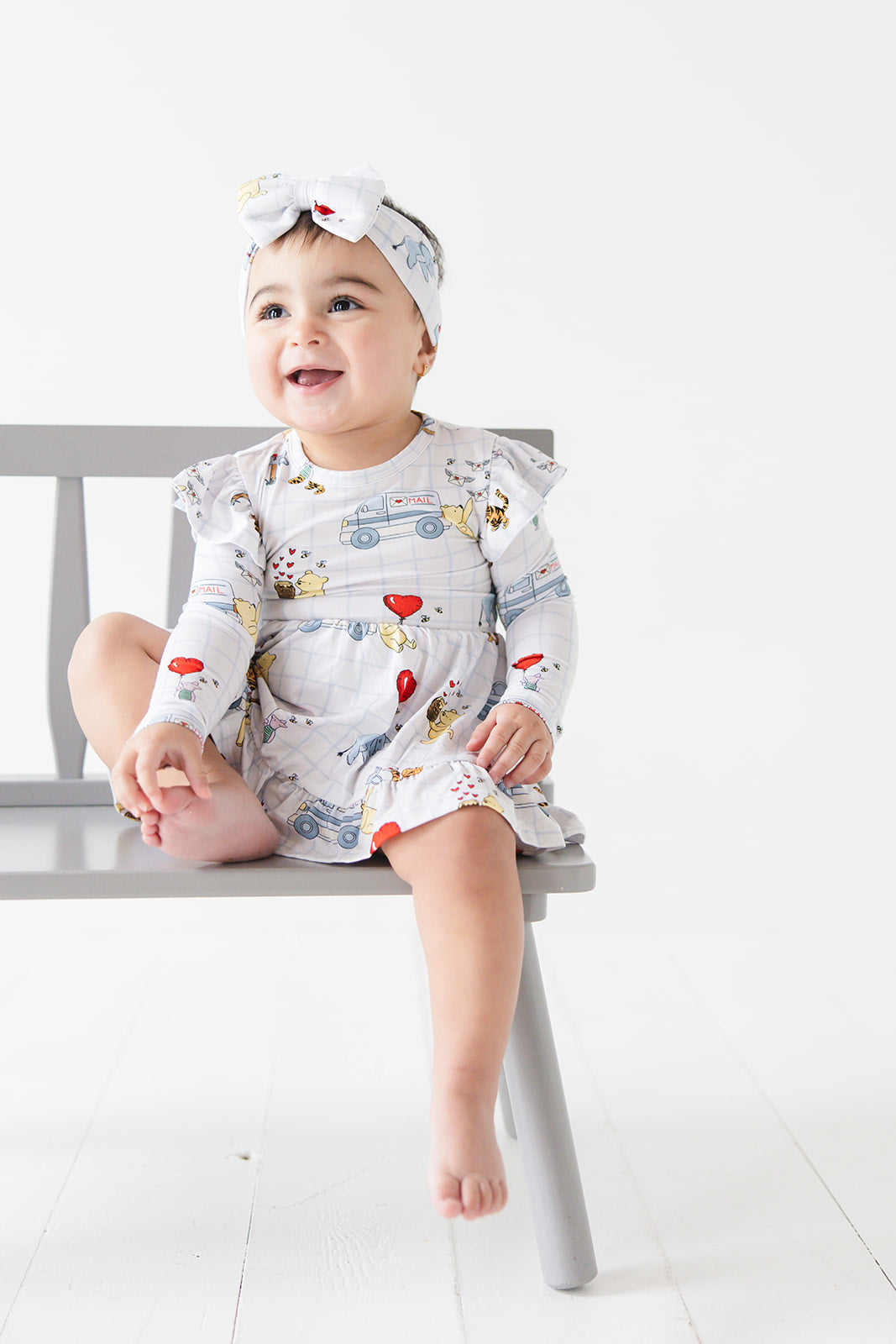 Vintage Winnie the Pooh bamboo twirl dress with Tigger, Eeyore and Piglet in a Valentine's Day print for baby and toddler boys and girls.