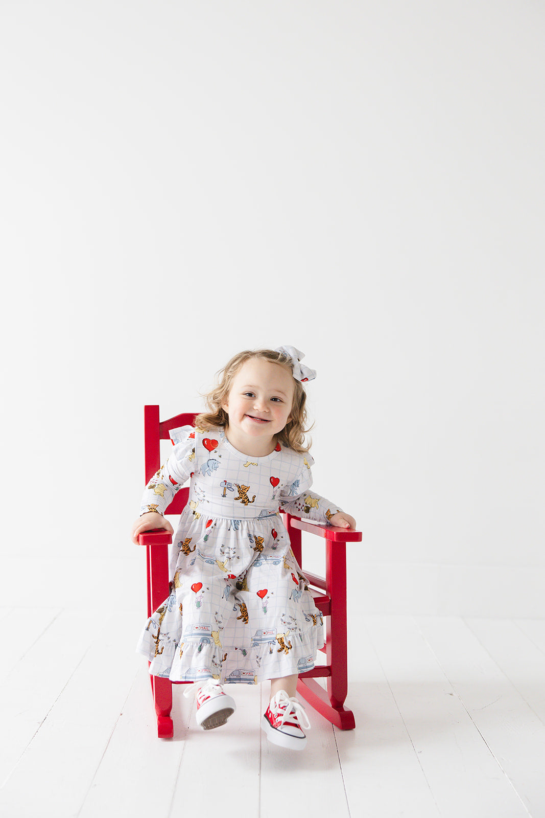 Vintage Winnie the Pooh bamboo twirl dress with Tigger, Eeyore and Piglet in a Valentine's Day print for baby and toddler boys and girls.