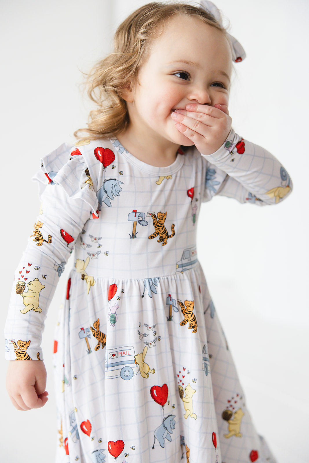 Vintage Winnie the Pooh bamboo twirl dress with Tigger, Eeyore and Piglet in a Valentine's Day print for baby and toddler boys and girls.