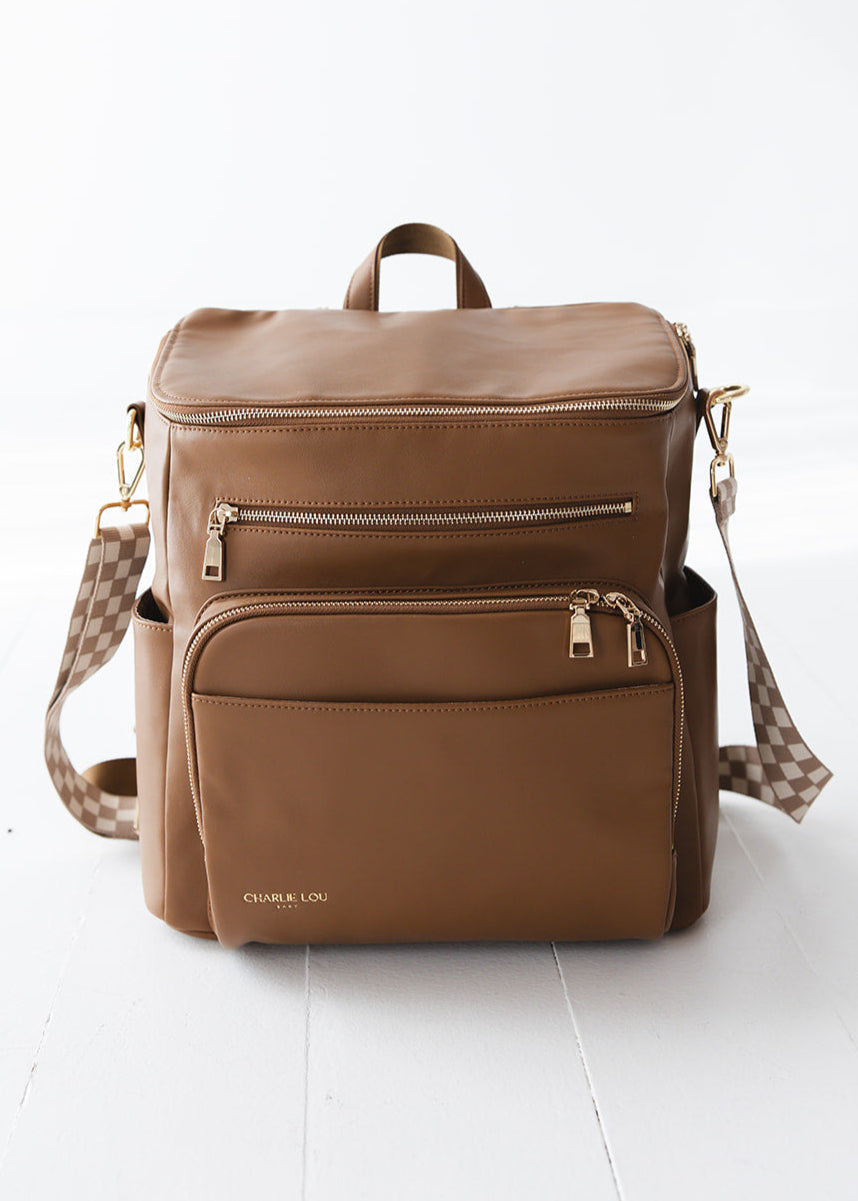 Brown faux leather large diaper bag with checkered cross body strap, insulated bottle pockets, changing mat, and stroller straps.