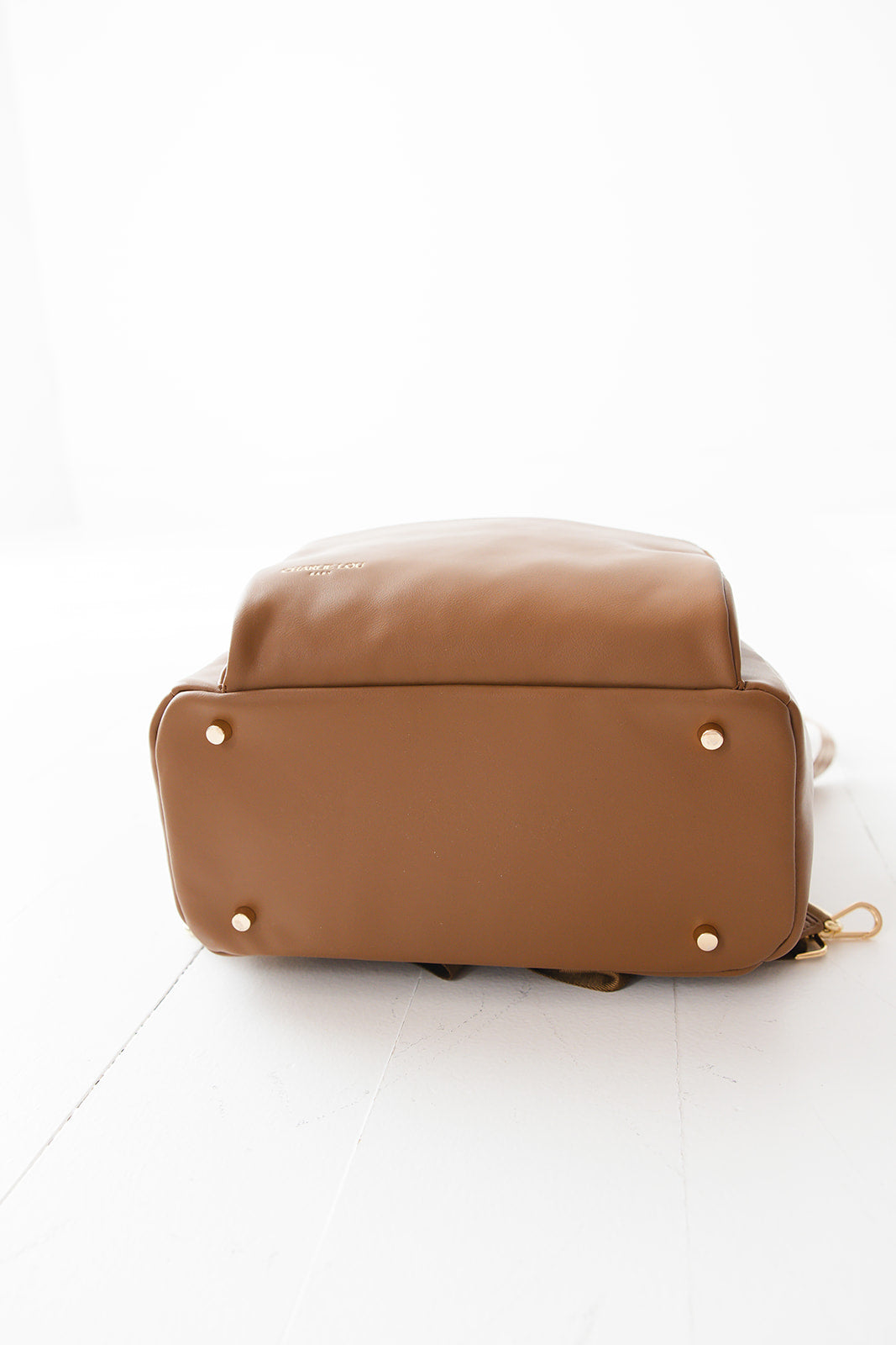 Brown faux leather large diaper bag with checkered cross body strap, insulated bottle pockets, changing mat, and stroller straps.