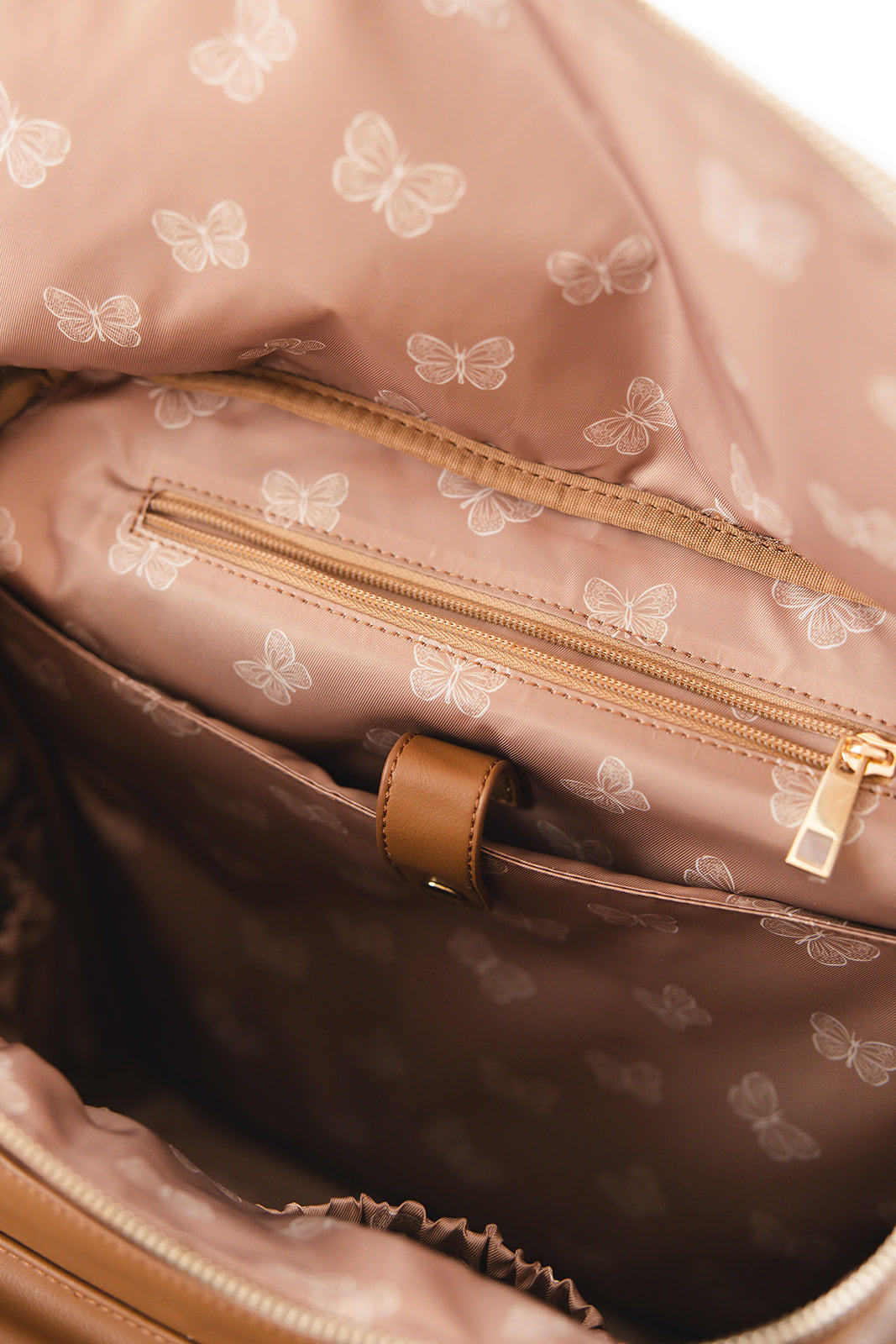 Brown faux leather large diaper bag with checkered cross body strap, insulated bottle pockets, changing mat, and stroller straps.