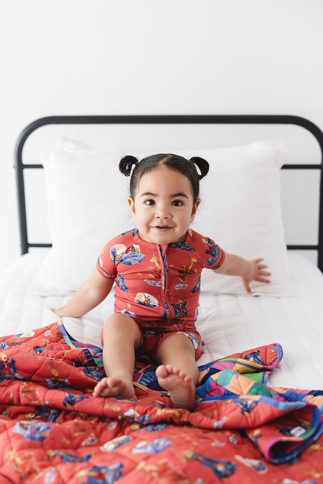 Bamboo double zipper shortie romper for babies and toddlers, both boys and girls. Print features a red background with Llama Llama Red Pajama.