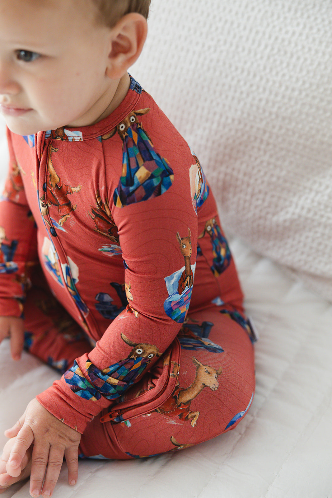 Bamboo convertible romper with hand and foot cuffs for babies and toddlers, both boys and girls. Print features a red background with Llama Llama Red Pajama.