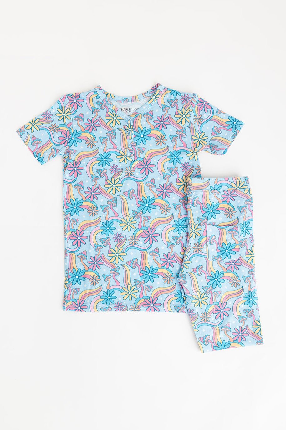 Bamboo pajama set for toddler girls in groovy, hippie, 70’s style print with mushrooms and florals on it. Button down collar and back pocket and the bamboo fabric is hypoallergenic, temperature regulating and is moisture wicking.