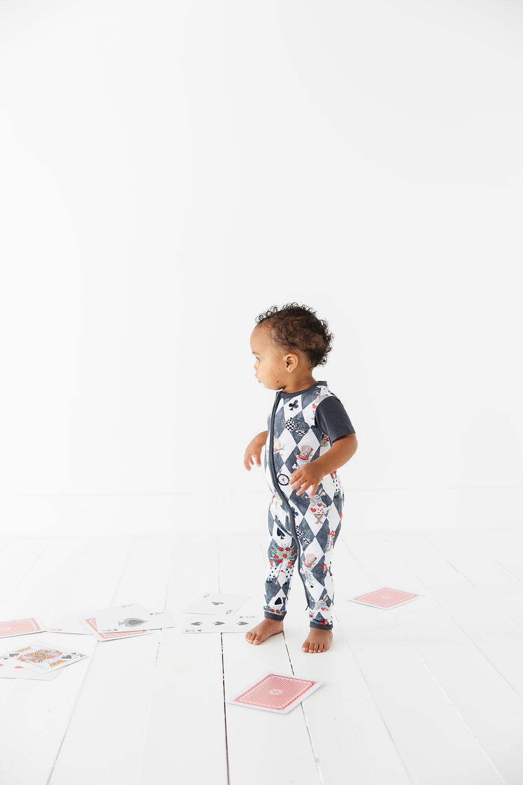 Short sleeve, double zipper romper for baby boys and girls. Gender neutral bamboo romper in Alice in Wonderland print.