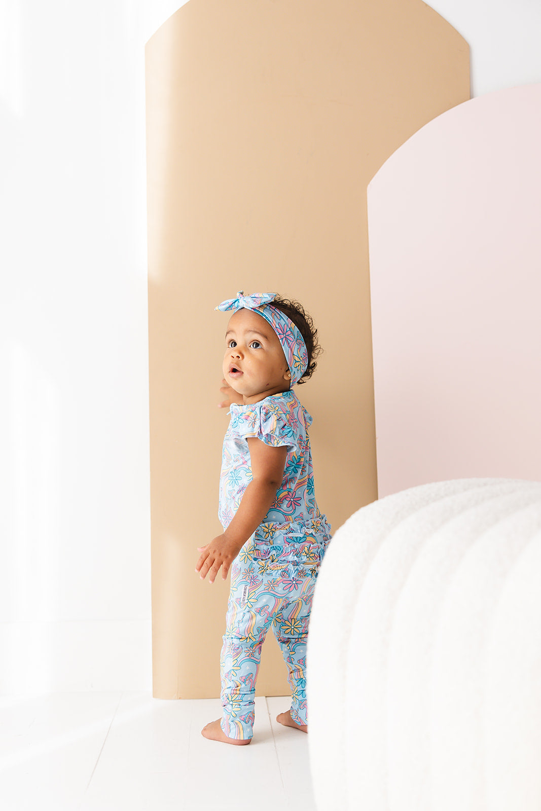Bamboo flutter short sleeve romper in groovy, hippie, 70’s style print with florals and mushrooms for baby girl.