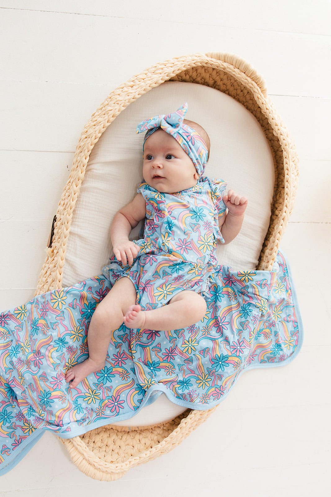 Bamboo bubble ruffle bodysuit with a groovy, hippie, 70’s style print that has florals and mushrooms on it for baby girls. This bamboo fabric has blues, pinks and oranges on it and is hypoallergenic, has UV protection and is temperature regulating.