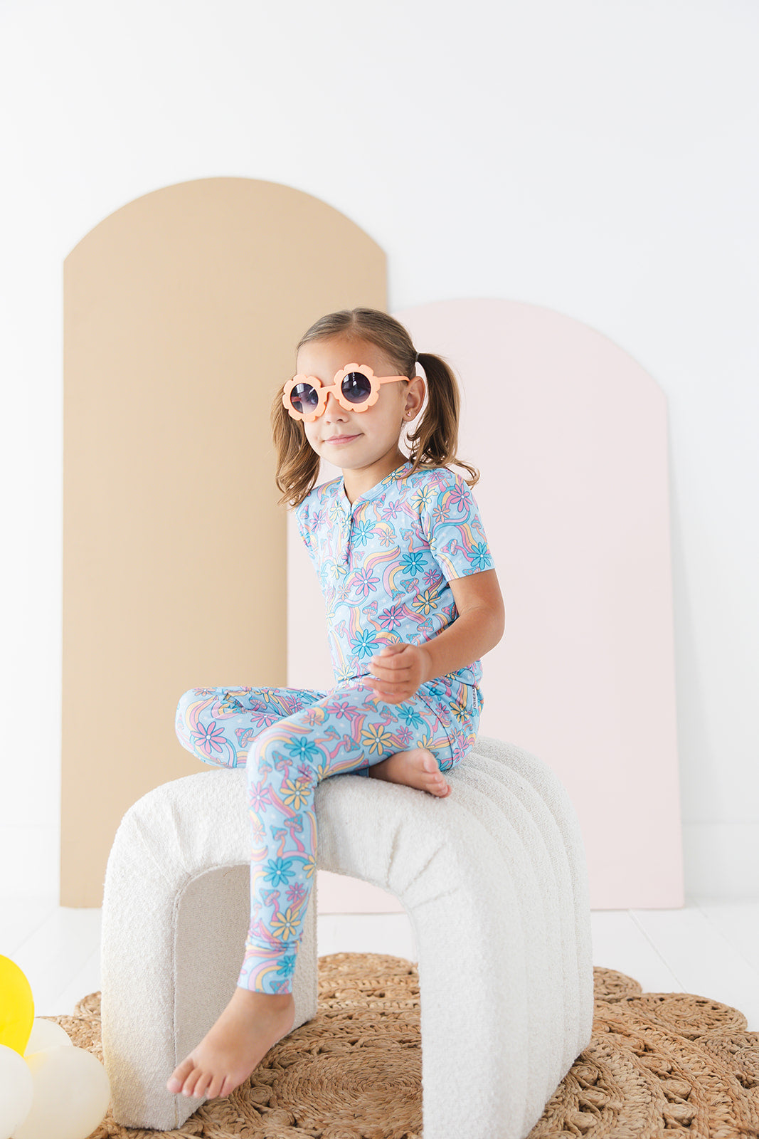 Bamboo pajama set for toddler girls in groovy, hippie, 70’s style print with mushrooms and florals on it. Button down collar and back pocket and the bamboo fabric is hypoallergenic, temperature regulating and is moisture wicking.
