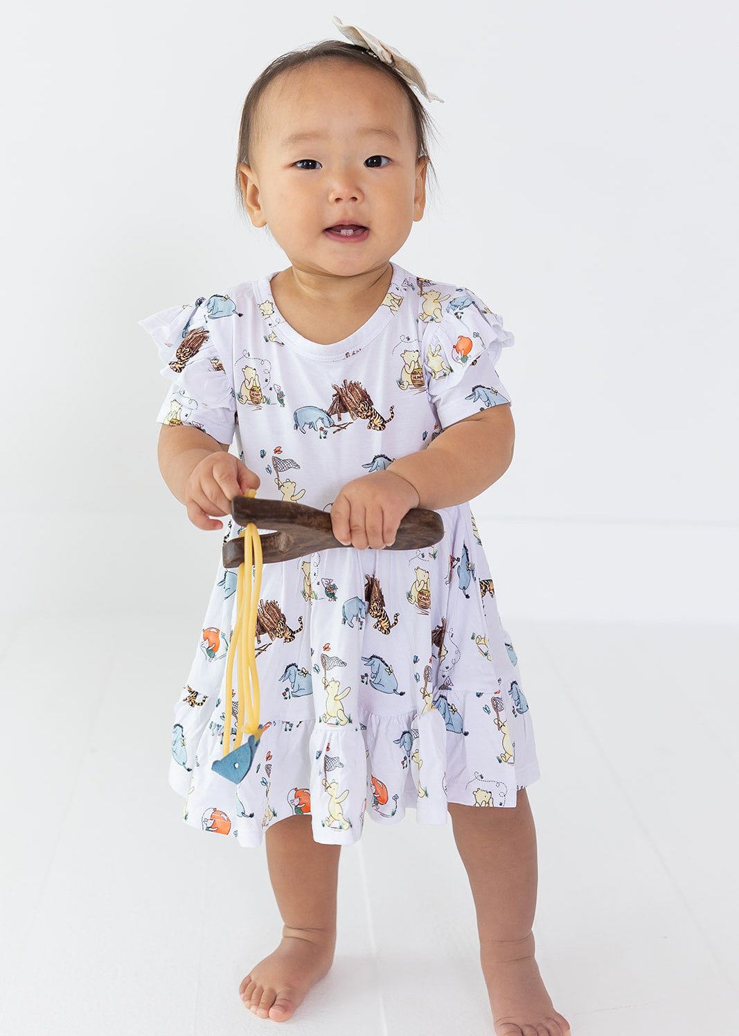 Little girl Winnie the Pooh bamboo twirl dress with matching shorts for Fall.