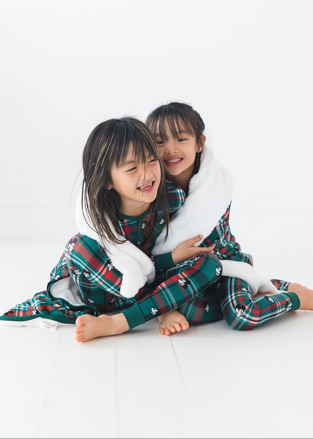 Green and red tartan bamboo plush blanket in Christmas Disney Mickey print.