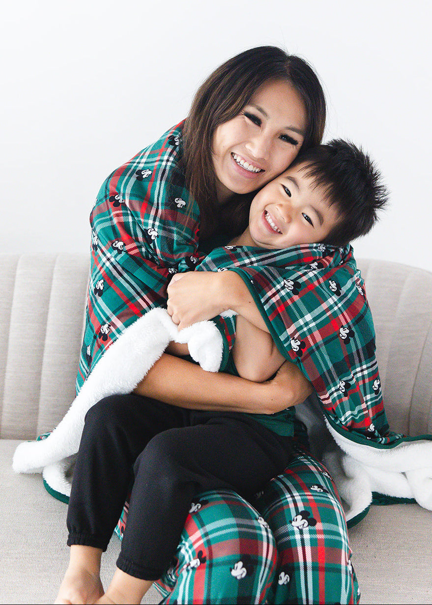 Green and red tartan bamboo plush blanket in Christmas Disney Mickey print.