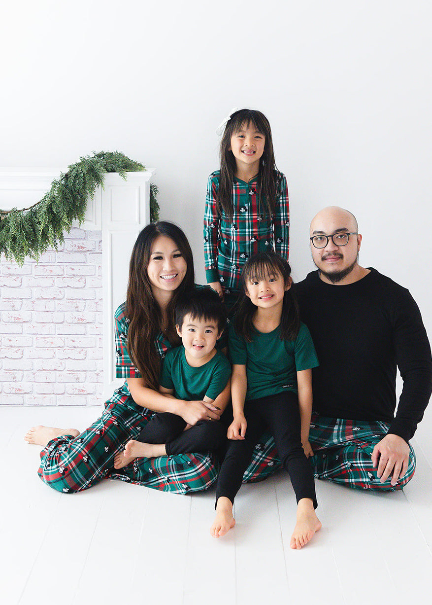 Family matching bamboo Christmas pajamas with Disney Mickey on green and red tartan print.