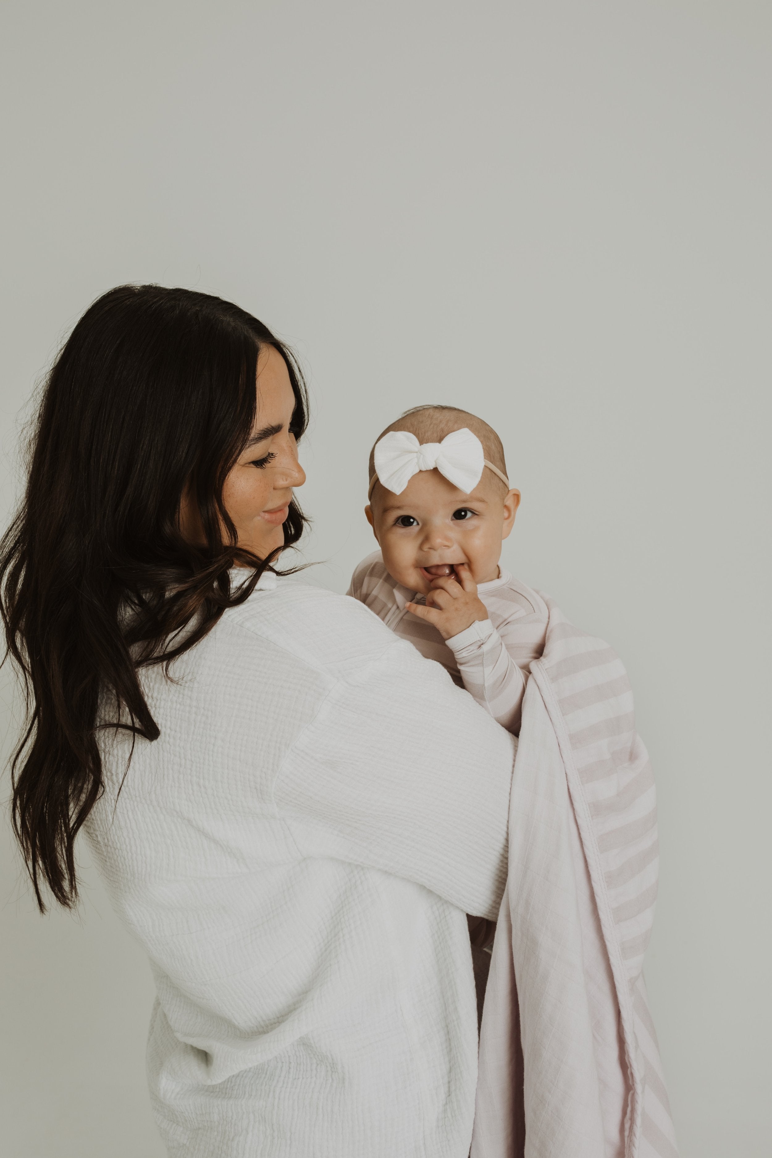 Gender neutral striped bamboo footed pajamas with double zipper.