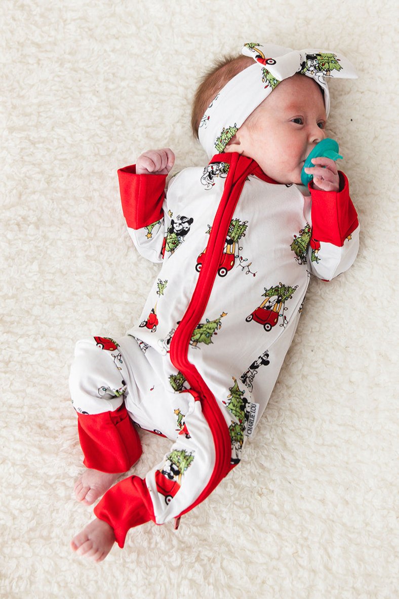 Gender-neutral convertible baby romper with hand and foot cuffs featuring a festive Steamboat Willie Christmas design with Minnie and Mickey Mouse. Includes a convenient double zipper for easy changes. Perfect for matching family Christmas pajamas.