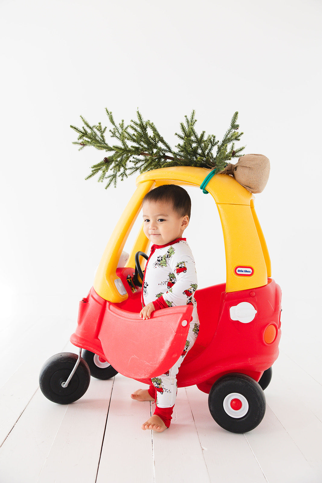 Gender-neutral convertible baby romper with hand and foot cuffs featuring a festive Steamboat Willie Christmas design with Minnie and Mickey Mouse. Includes a convenient double zipper for easy changes. Perfect for matching family Christmas pajamas.