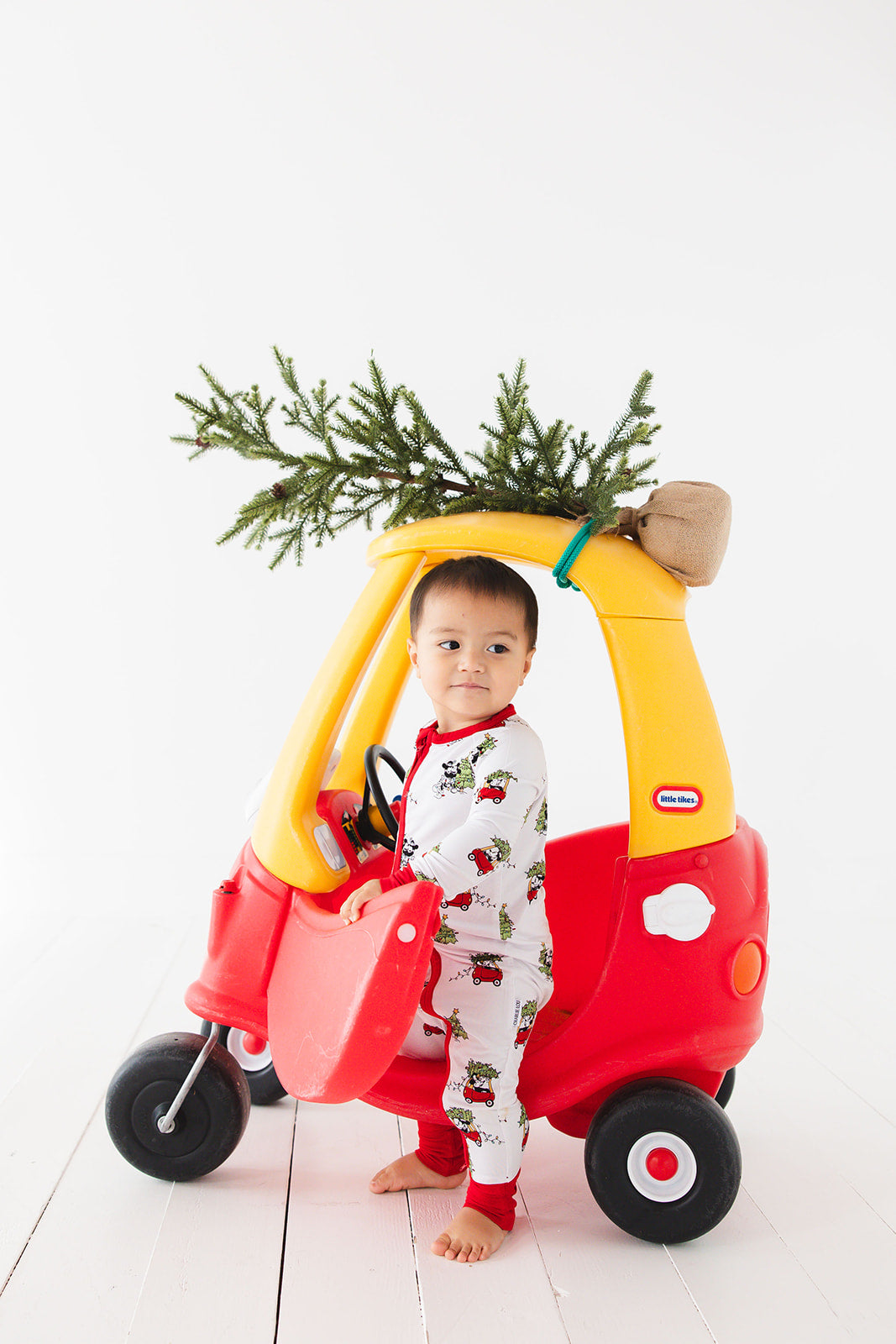 Gender-neutral convertible baby romper with hand and foot cuffs featuring a festive Steamboat Willie Christmas design with Minnie and Mickey Mouse. Includes a convenient double zipper for easy changes. Perfect for matching family Christmas pajamas.