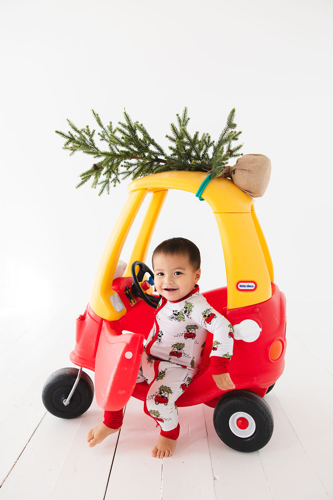 Gender-neutral convertible baby romper with hand and foot cuffs featuring a festive Steamboat Willie Christmas design with Minnie and Mickey Mouse. Includes a convenient double zipper for easy changes. Perfect for matching family Christmas pajamas.