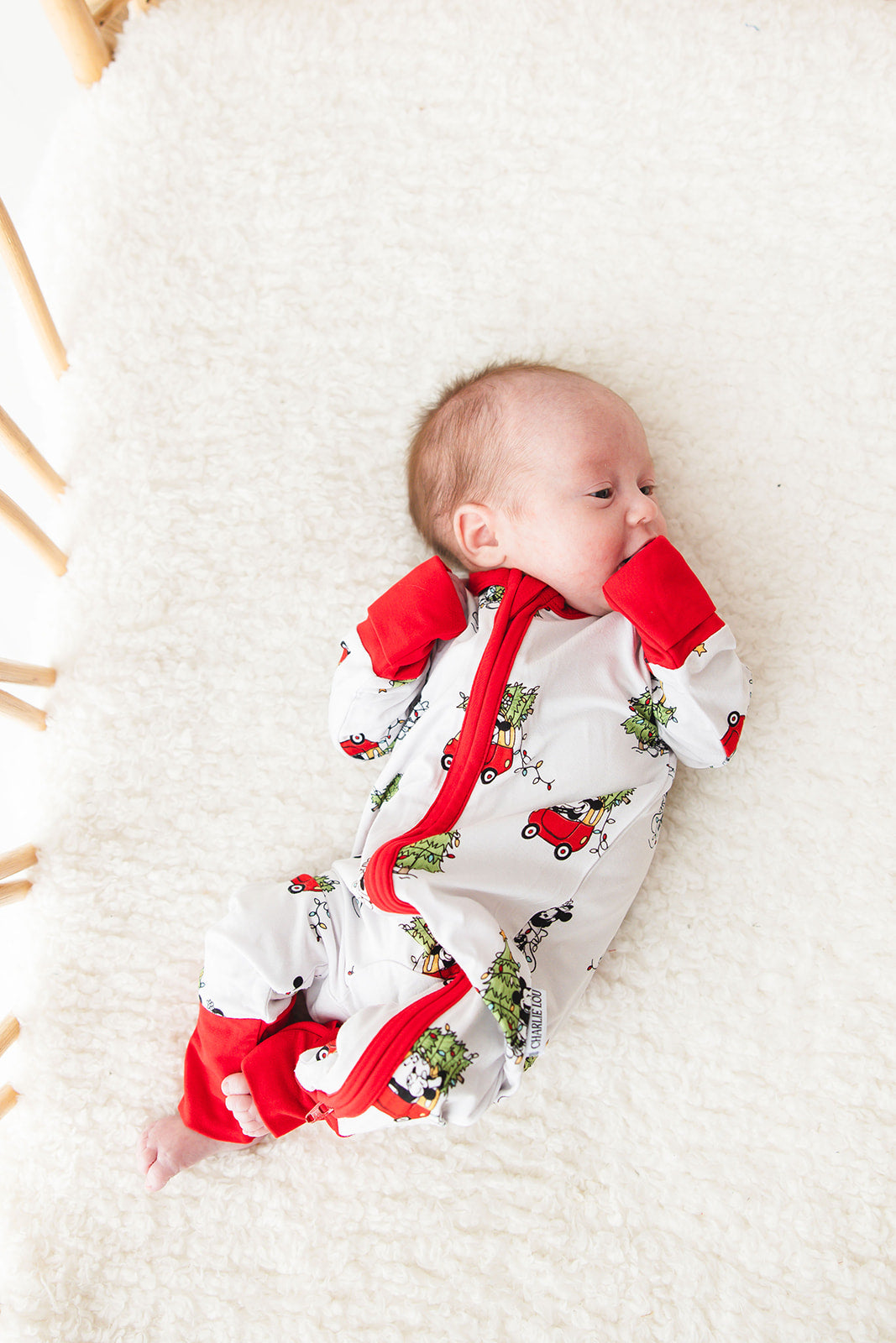 Gender-neutral convertible baby romper with hand and foot cuffs featuring a festive Steamboat Willie Christmas design with Minnie and Mickey Mouse. Includes a convenient double zipper for easy changes. Perfect for matching family Christmas pajamas.