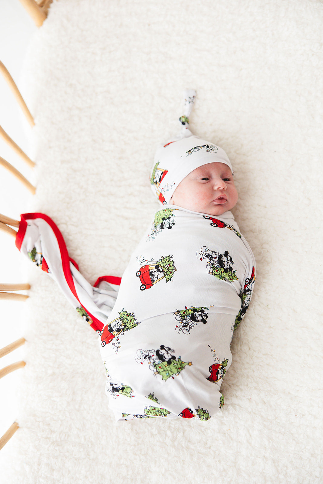 Gender-neutral bamboo swaddle featuring a festive Steamboat Willie Christmas design with Minnie and Mickey Mouse. Soft, breathable fabric perfect for babies, ideal for matching family Christmas pajamas. A cozy holiday essential for little ones.