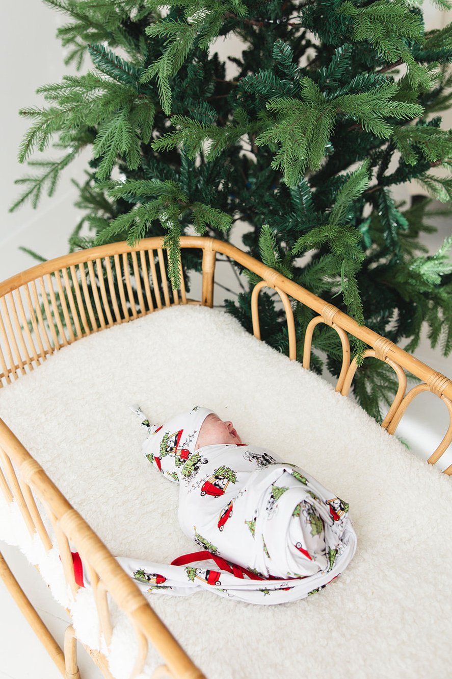 Gender-neutral bamboo swaddle featuring a festive Steamboat Willie Christmas design with Minnie and Mickey Mouse. Soft, breathable fabric perfect for babies, ideal for matching family Christmas pajamas. A cozy holiday essential for little ones.