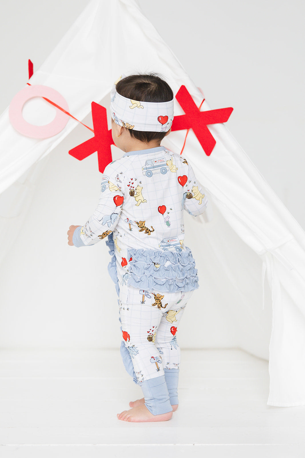 Vintage Winnie the Pooh bamboo pajama Ruffle Convertible Romper with Tigger, Eeyore and Piglet in a Valentine's Day print for baby and toddler boys and girls. Perfect for sibling matching and gender neutral.