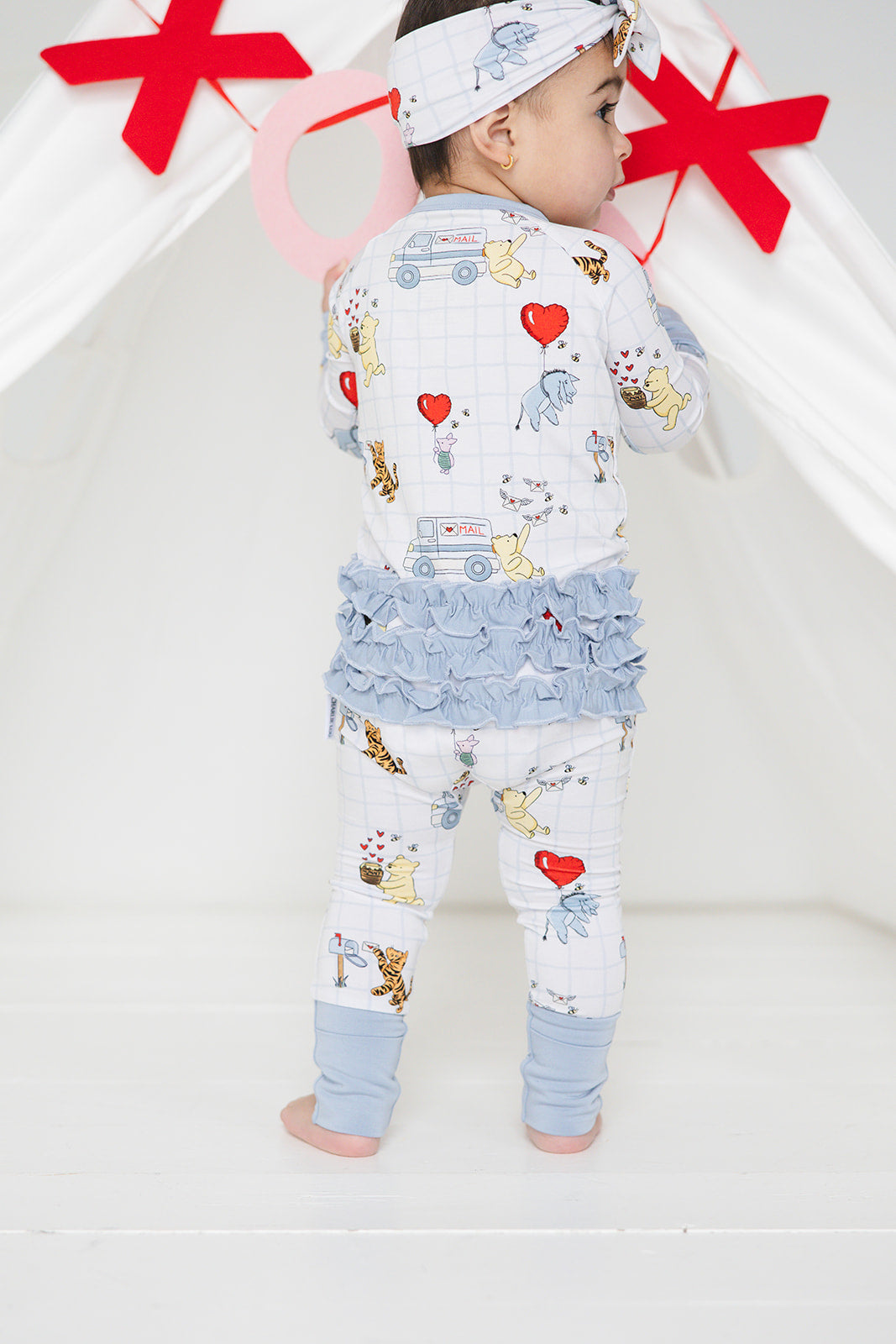 Vintage Winnie the Pooh bamboo pajama Ruffle Convertible Romper with Tigger, Eeyore and Piglet in a Valentine's Day print for baby and toddler boys and girls. Perfect for sibling matching and gender neutral.