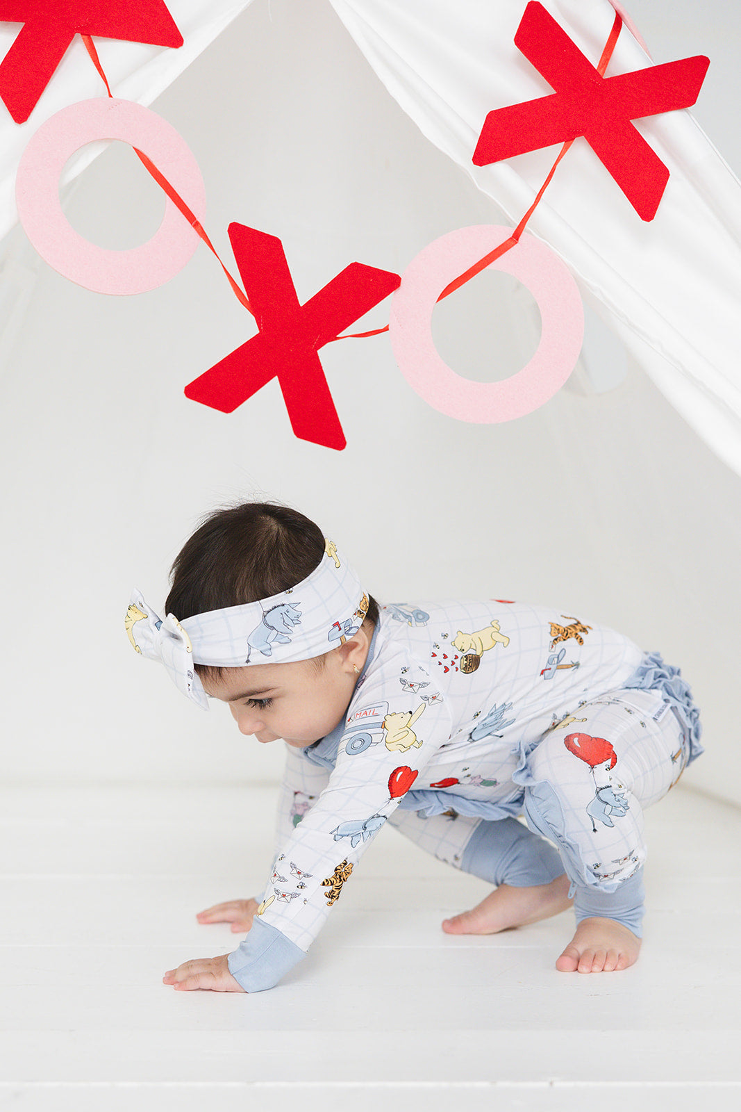 Vintage Winnie the Pooh bamboo pajama Ruffle Convertible Romper with Tigger, Eeyore and Piglet in a Valentine's Day print for baby and toddler boys and girls. Perfect for sibling matching and gender neutral.