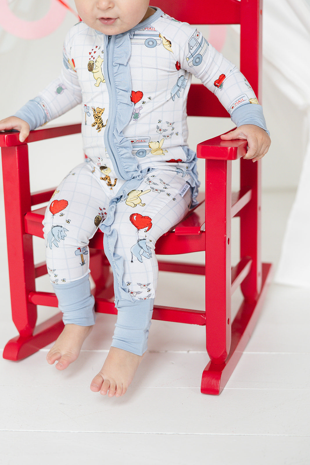 Vintage Winnie the Pooh bamboo pajama Ruffle Convertible Romper with Tigger, Eeyore and Piglet in a Valentine's Day print for baby and toddler boys and girls. Perfect for sibling matching and gender neutral.