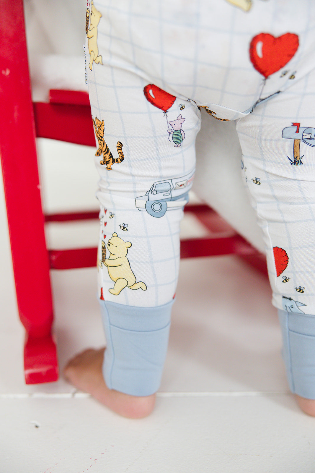 Vintage Winnie the Pooh bamboo pajama Ruffle Convertible Romper with Tigger, Eeyore and Piglet in a Valentine's Day print for baby and toddler boys and girls. Perfect for sibling matching and gender neutral.