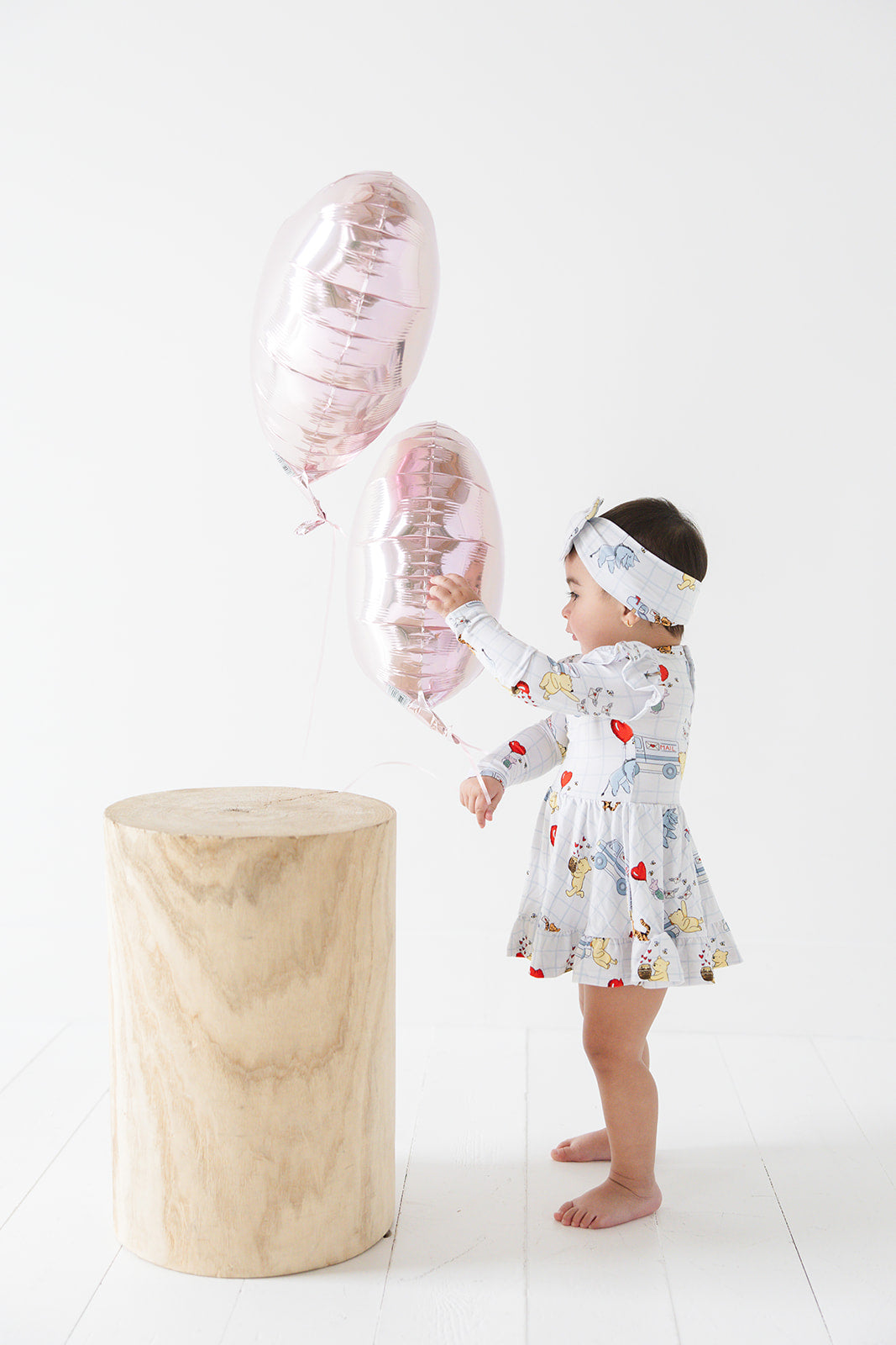 Vintage Winnie the Pooh bamboo twirl dress with Tigger, Eeyore and Piglet in a Valentine's Day print for baby and toddler boys and girls.