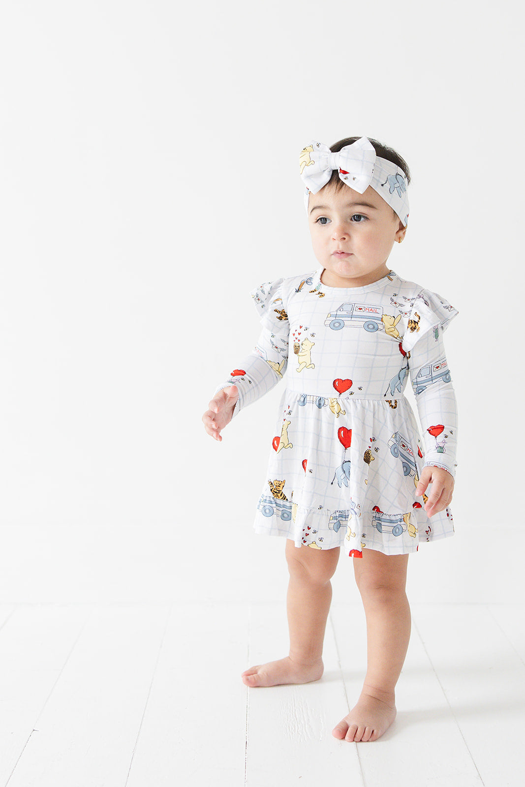 Vintage Winnie the Pooh bamboo twirl dress with Tigger, Eeyore and Piglet in a Valentine's Day print for baby and toddler boys and girls.