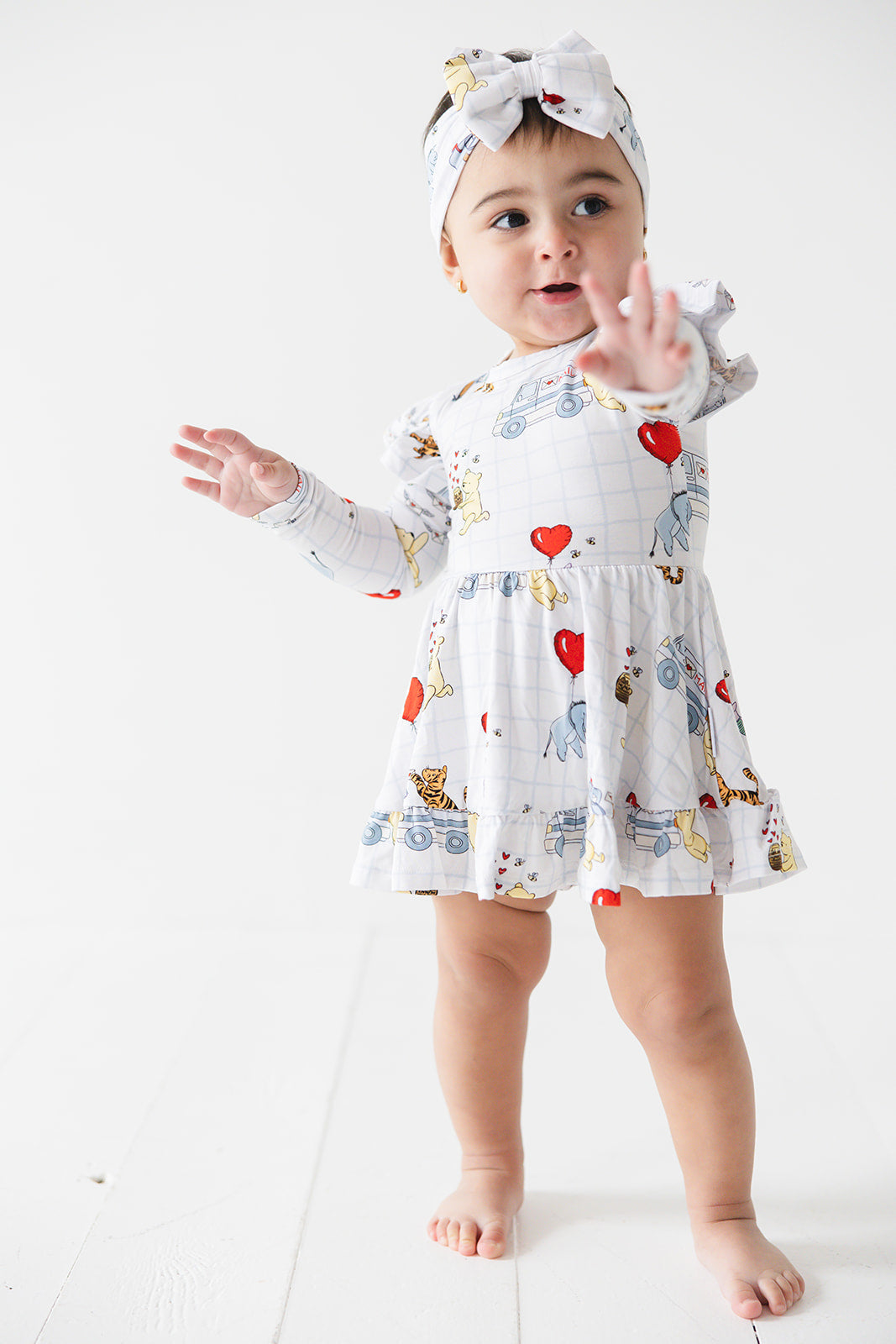 Vintage Winnie the Pooh bamboo twirl dress with Tigger, Eeyore and Piglet in a Valentine's Day print for baby and toddler boys and girls.
