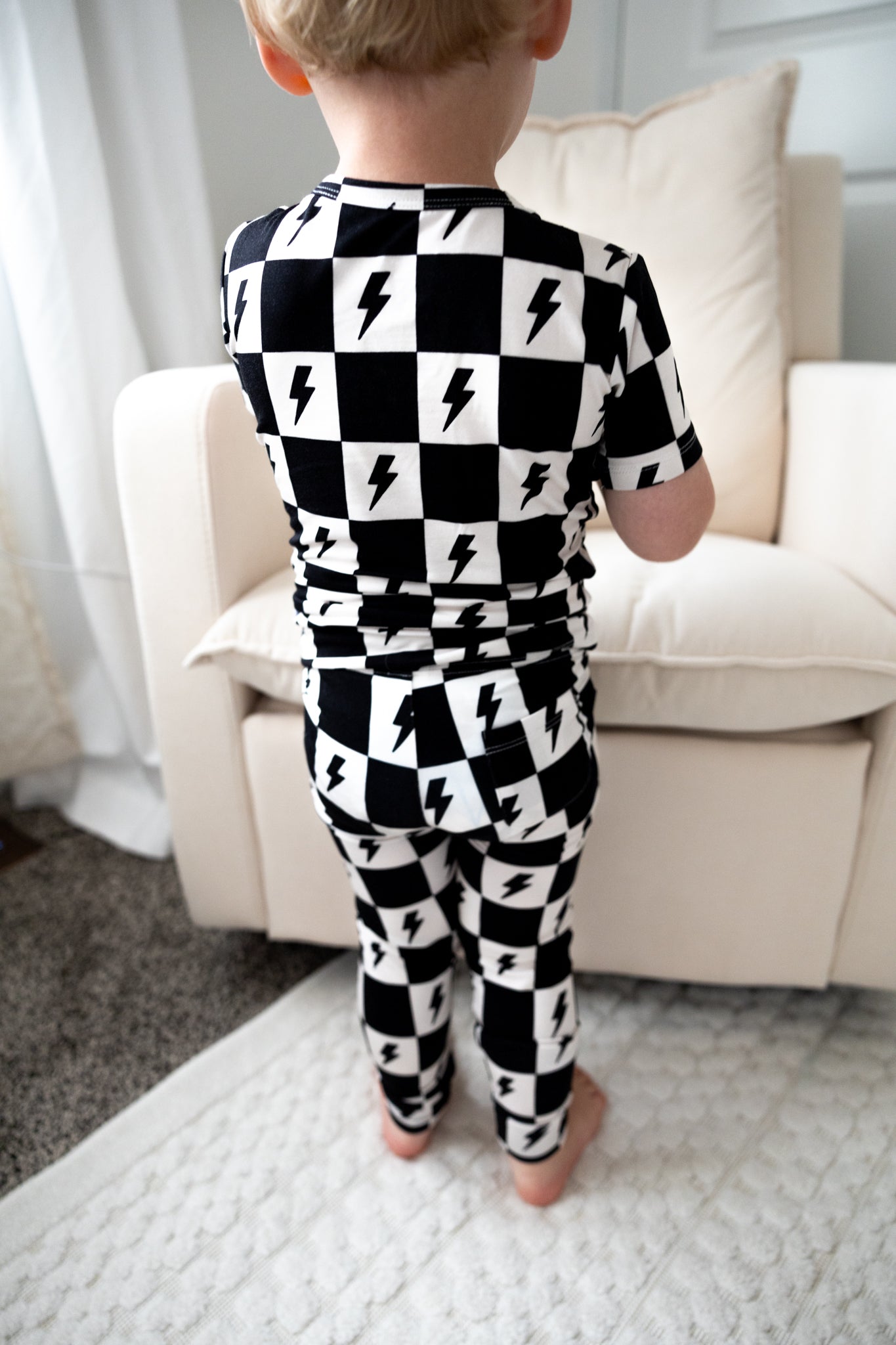 Bamboo boy and girl pajama set with checkers and lightning bolts.