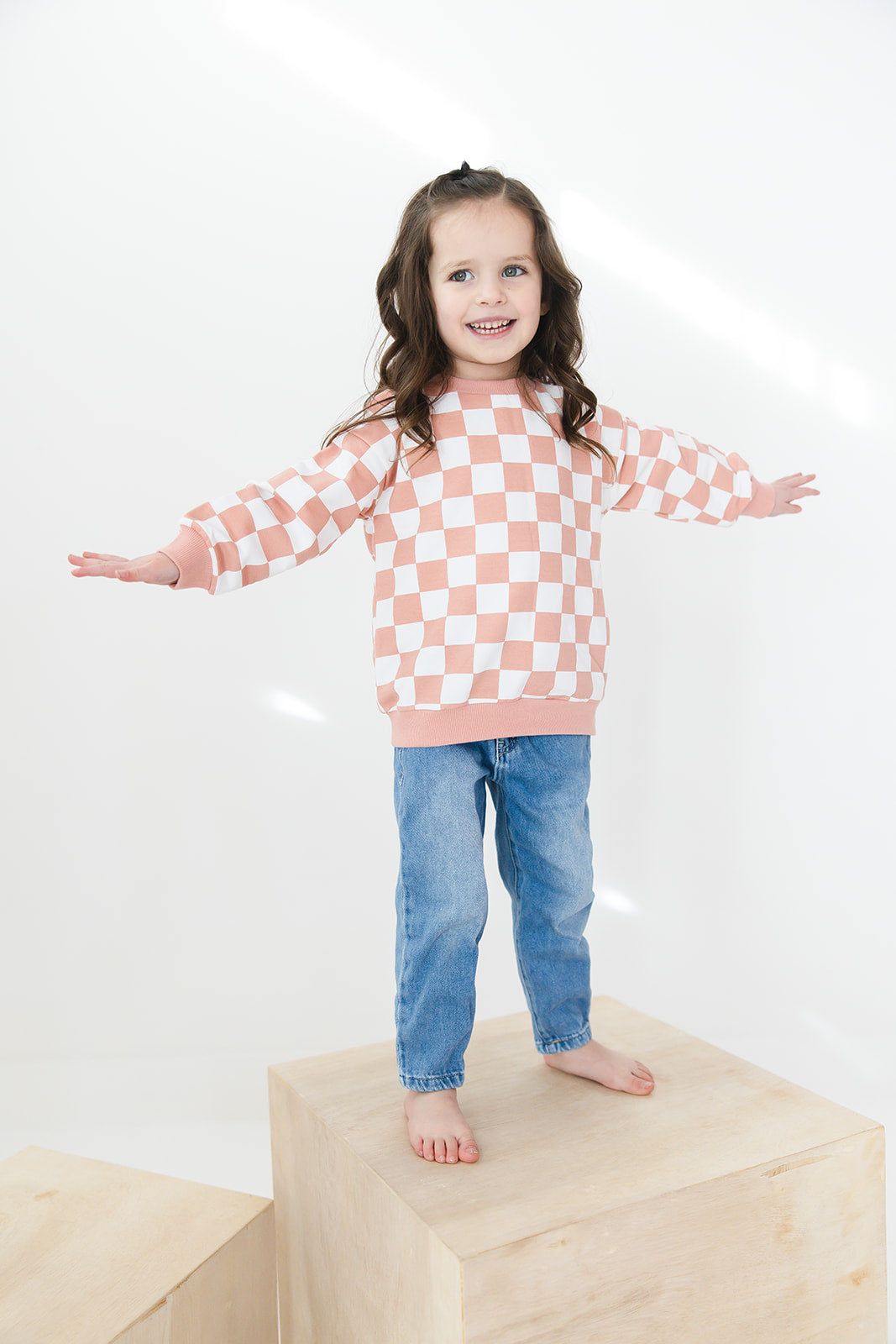 Pink checkered organic cotton sweater for babies and toddlers, both boys and girls.