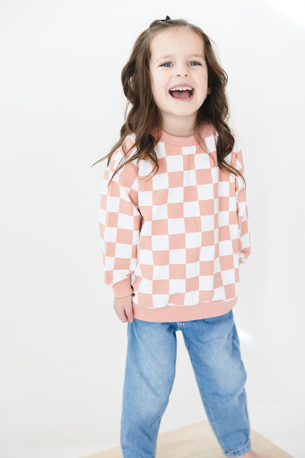 Pink checkered organic cotton sweater for babies and toddlers, both boys and girls.