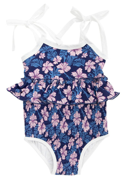 Bathing suit for baby, toddler and little girls. One piece swim suit with pink florals and blue background that is ribbed fabric on the top and smocked on the bottom with adjustable straps that tie into bows.