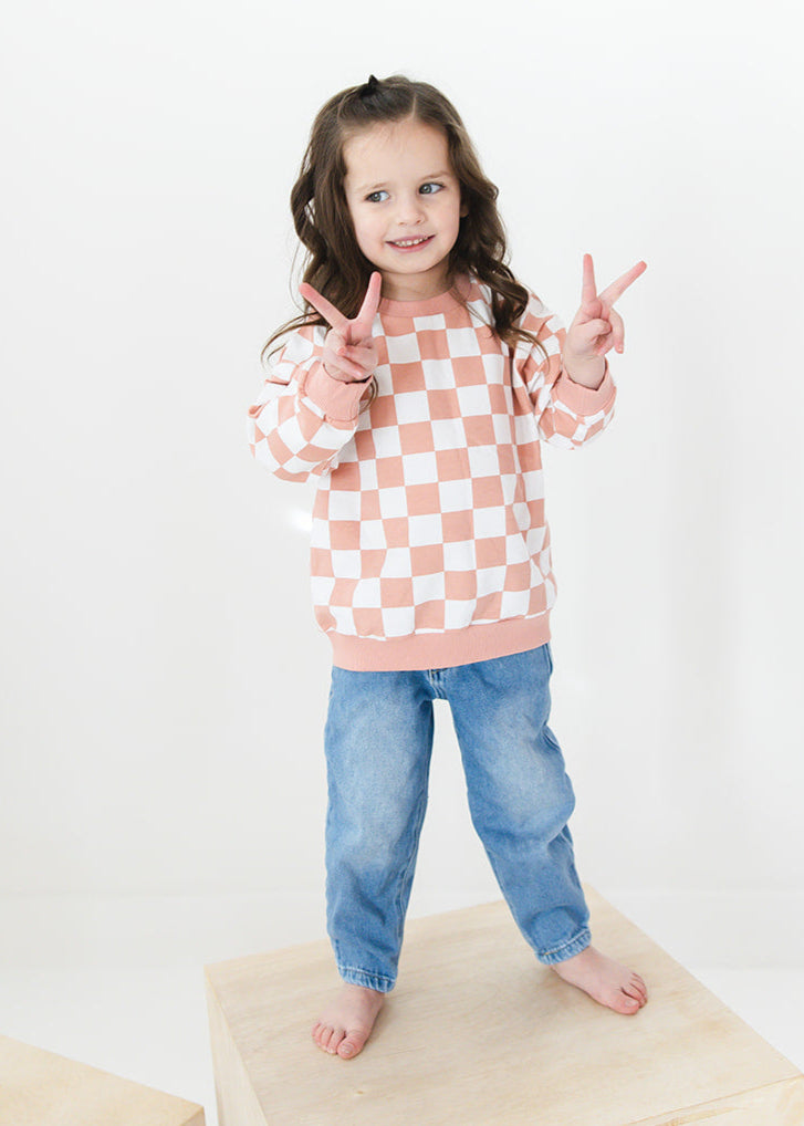 Pink checkered organic cotton sweater for babies and toddlers, both boys and girls.