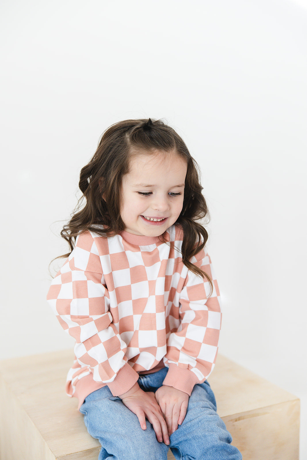 Pink checkered organic cotton sweater for babies and toddlers, both boys and girls.