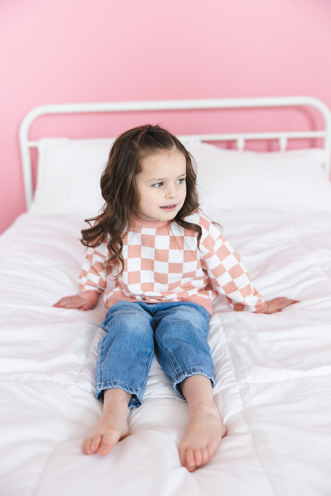 Pink checkered organic cotton sweater for babies and toddlers, both boys and girls.