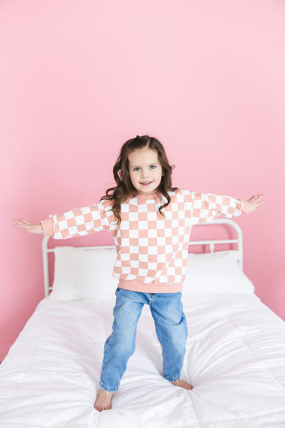 Pink checkered organic cotton sweater for babies and toddlers, both boys and girls.