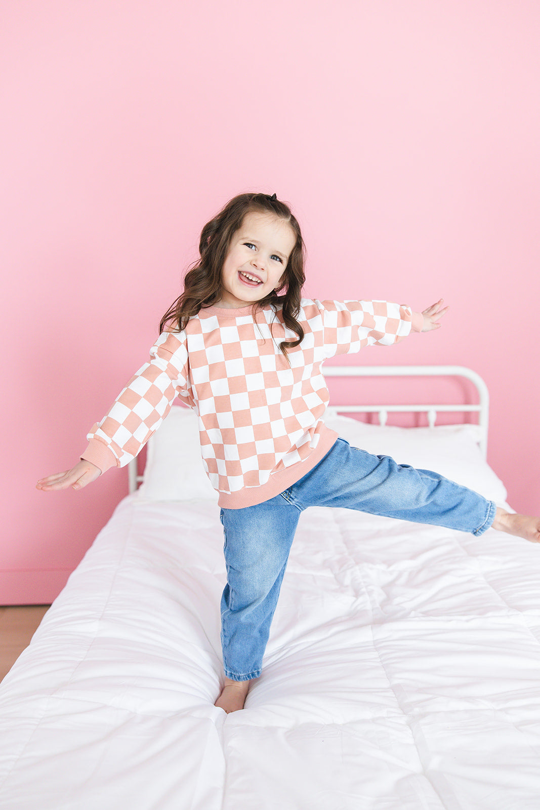 Pink checkered organic cotton sweater for babies and toddlers, both boys and girls.