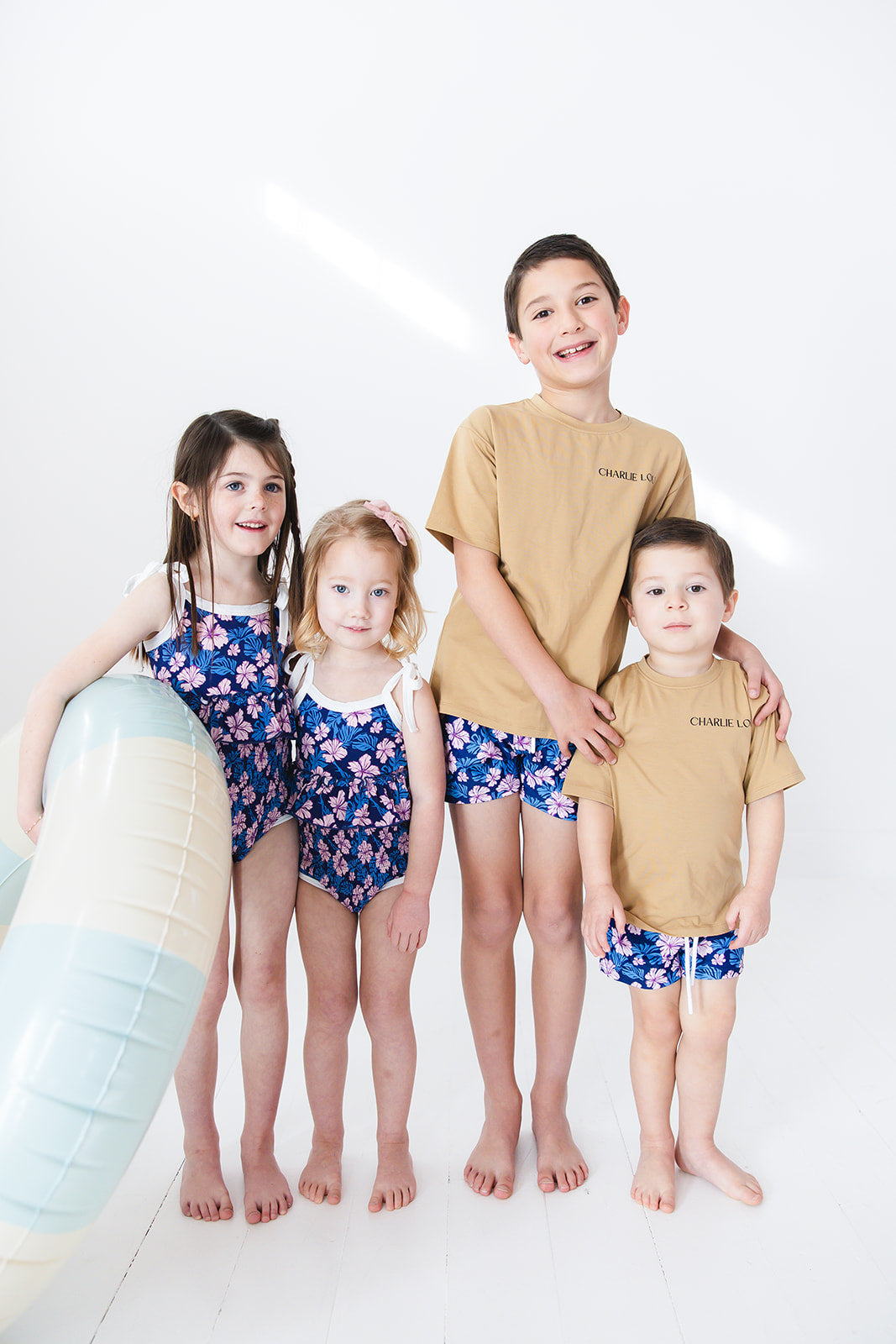 Sibling matching swimsuits and t-shirts.