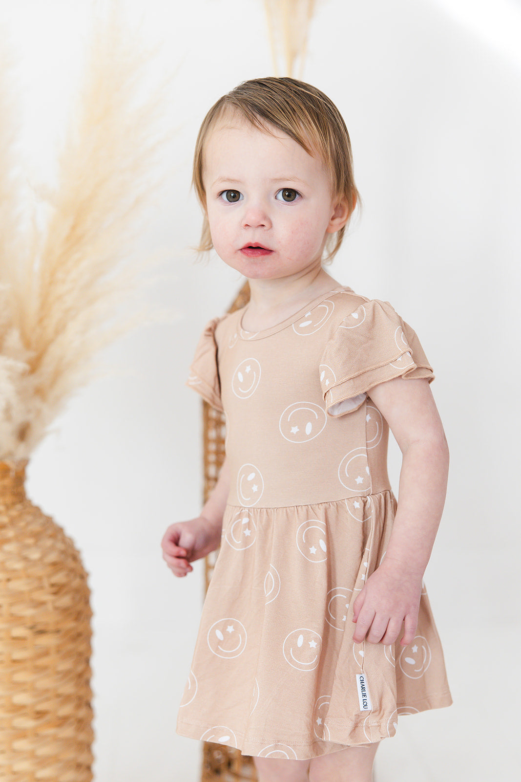 Girl bamboo twirl dress for baby girls or toddler girls in Smiley Face Star print with bodysuit.