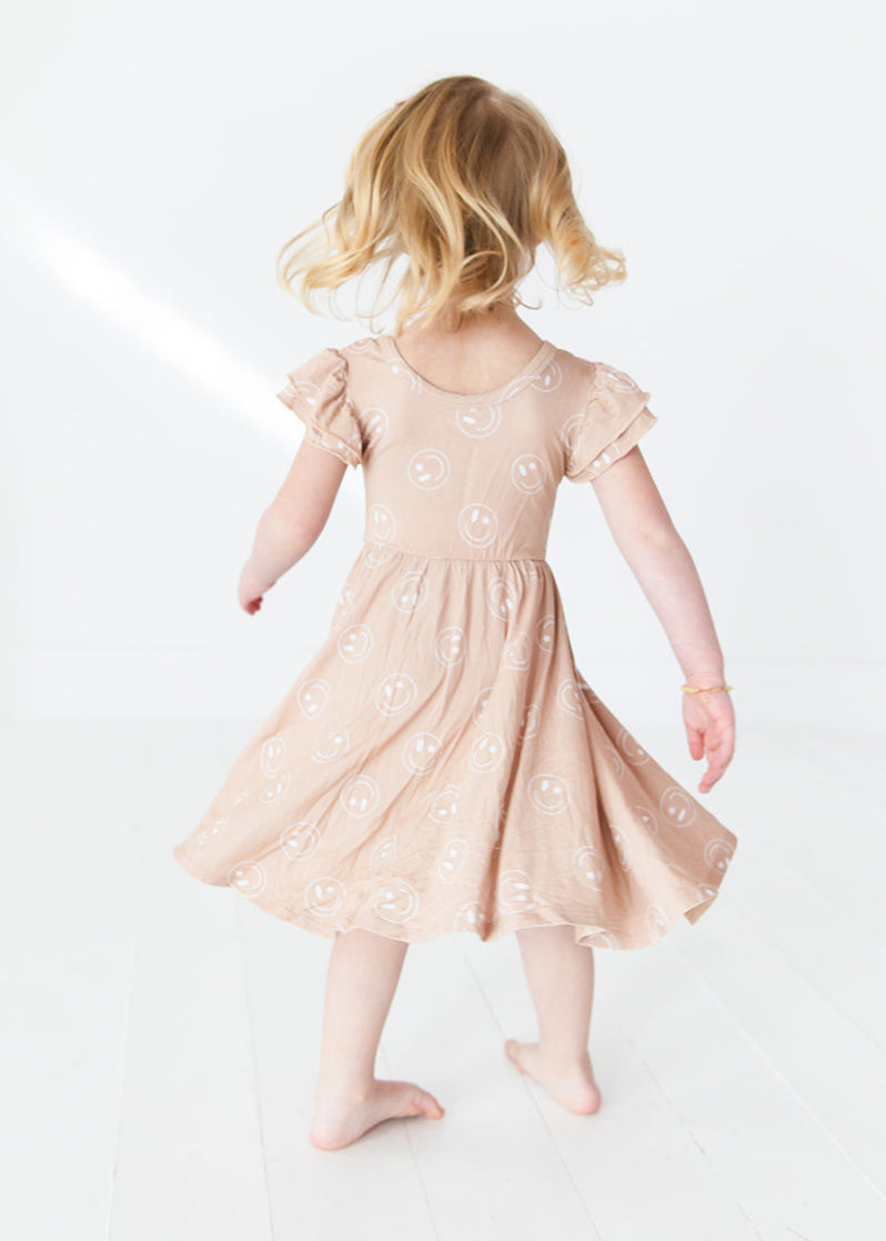 Girl bamboo twirl dress for baby girls or toddler girls in Smiley Face Star print with bodysuit.