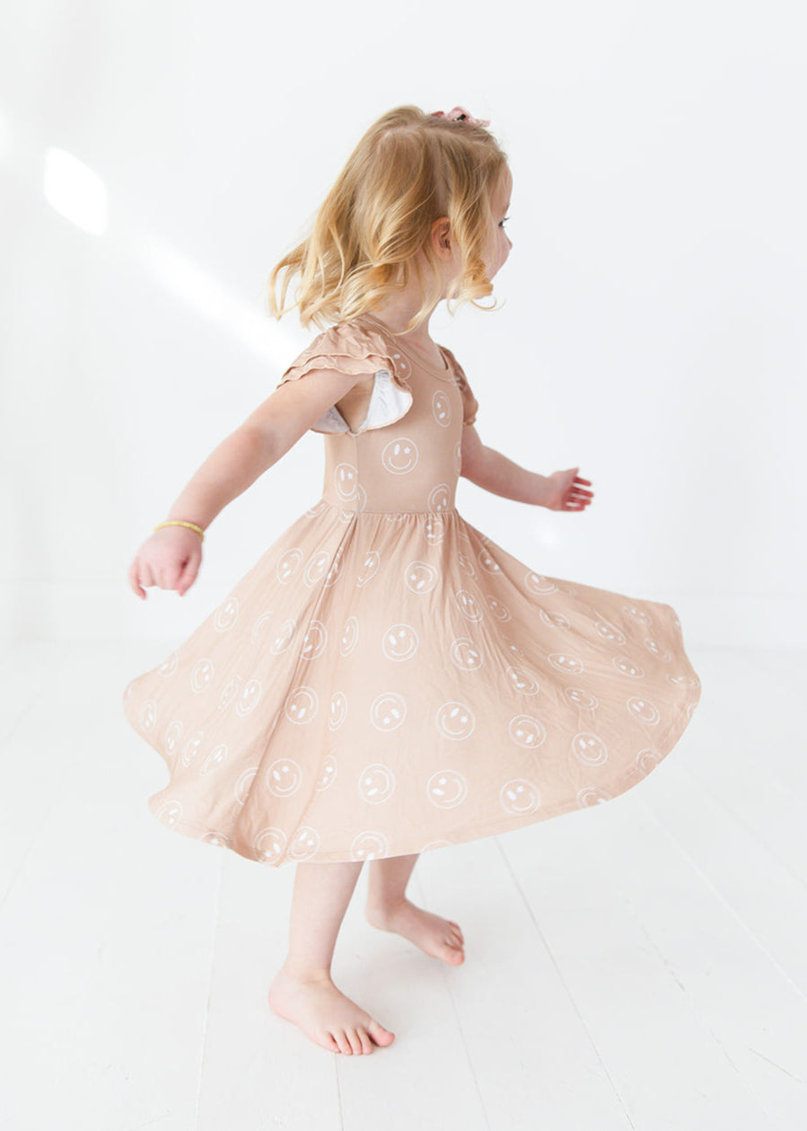 Girl bamboo twirl dress for baby girls or toddler girls in Smiley Face Star print with bodysuit.