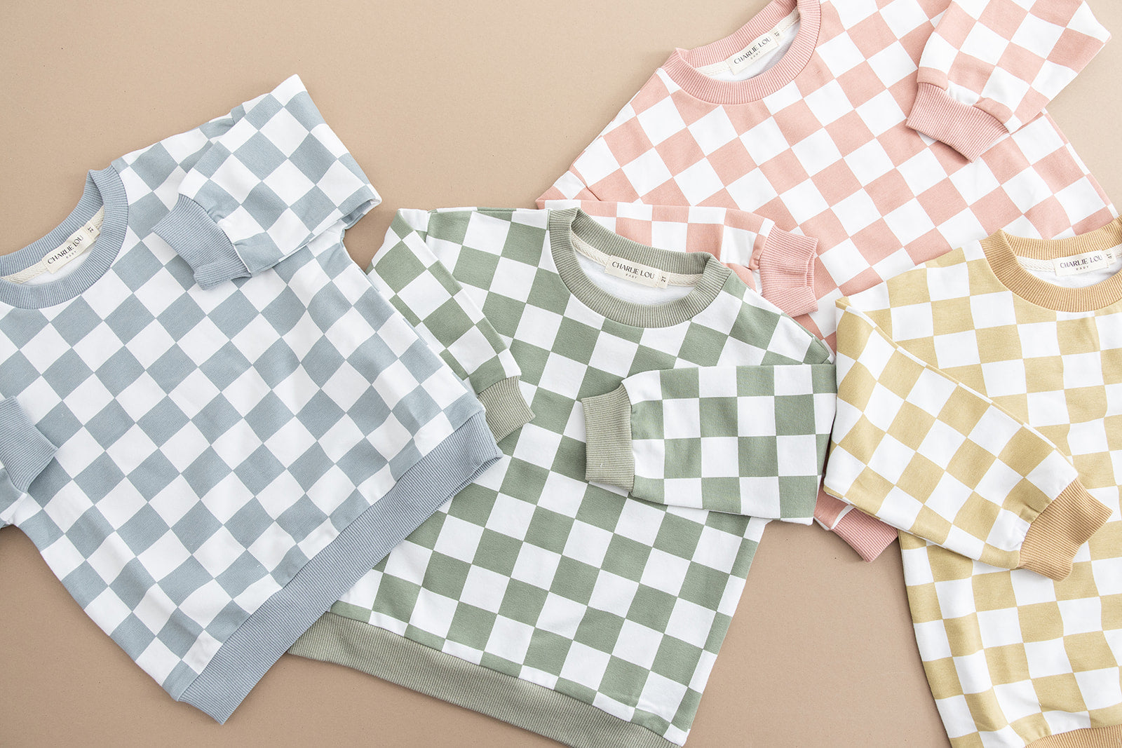 Pink checkered organic cotton sweater for babies and toddlers, both boys and girls.